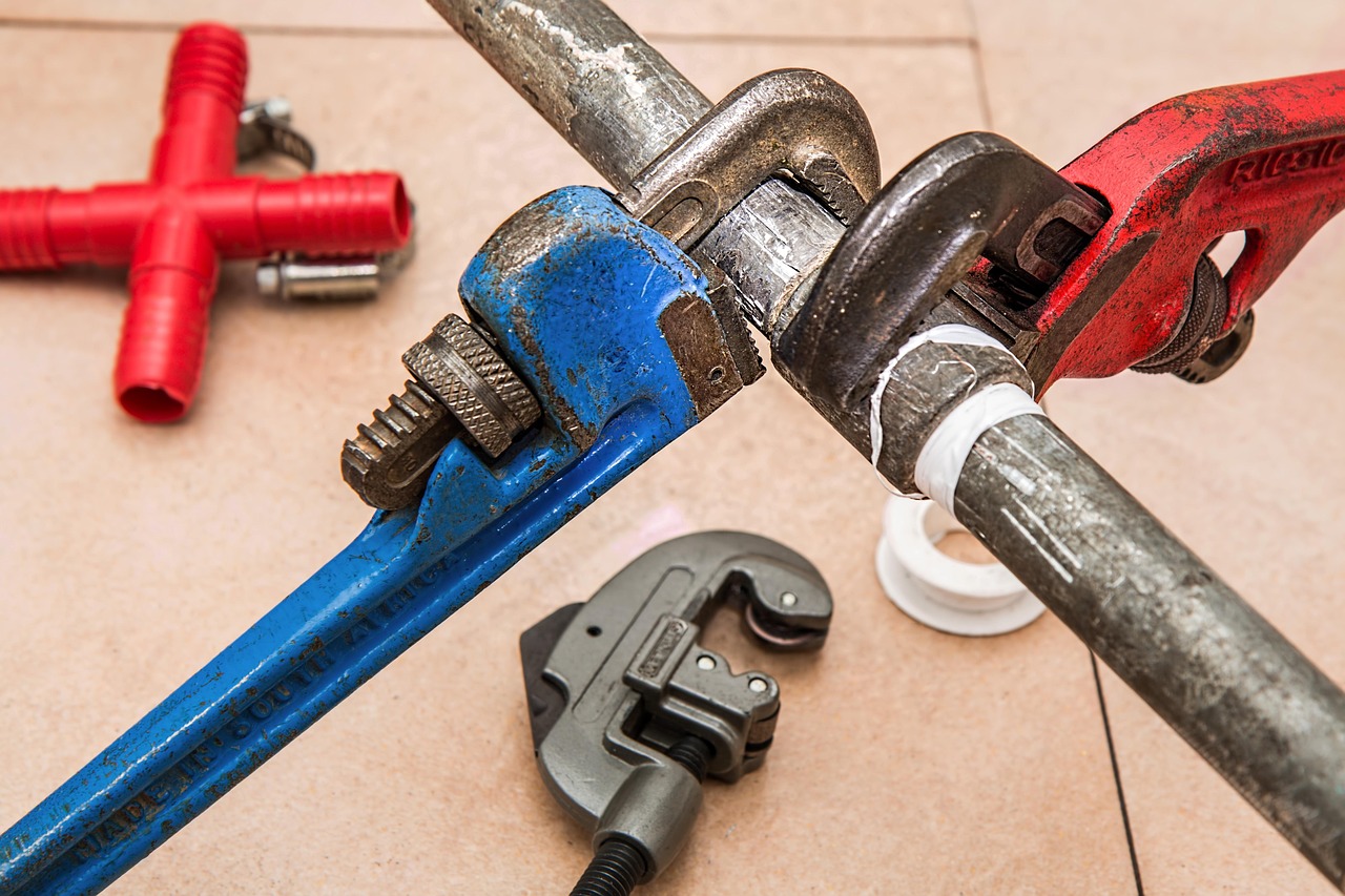 Flatlay of plumbing tools and wrenches